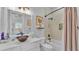 Bathroom featuring large mirror, modern sink, and a shower-tub combo at 5676 Case Ln, Lakeland, FL 33813
