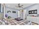 bedroom with blue walls, ceiling fan, tv, and a checkered comforter at 5676 Case Ln, Lakeland, FL 33813