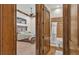Bedroom featuring wooden trim and bath with patterned tile through doorway at 5676 Case Ln, Lakeland, FL 33813