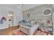 Well-lit bedroom featuring wood accent wall and an en-suite bathroom at 5676 Case Ln, Lakeland, FL 33813