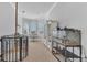 Open bonus room with unique wrought iron railing and a dining area in background at 5676 Case Ln, Lakeland, FL 33813