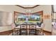 Elegant dining room featuring backyard view, modern chandelier, and wood flooring at 5676 Case Ln, Lakeland, FL 33813