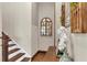 Elegant foyer with hardwood floors, staircase, arched mirror, and decorative accents at 5676 Case Ln, Lakeland, FL 33813