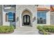 The decorative iron double doors, framed by stone and elegant lighting, create a grand and inviting entrance at 5676 Case Ln, Lakeland, FL 33813