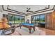 Bright game room features a pool table, a bar area, and outdoor views, creating a relaxing and fun ambiance at 5676 Case Ln, Lakeland, FL 33813