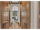 Hallway with wooden ceiling trim and sliding barn doors leads to a brightly lit room with large windows at 5676 Case Ln, Lakeland, FL 33813
