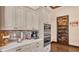 Modern kitchen with stainless appliances, custom cabinetry, and a walk-in pantry at 5676 Case Ln, Lakeland, FL 33813