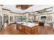 An open kitchen featuring a large island, stainless steel sink, and wood cabinetry at 5676 Case Ln, Lakeland, FL 33813