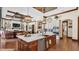 A gourmet kitchen boasts a large island, copper sink, stainless appliances, and is open to the home's living room at 5676 Case Ln, Lakeland, FL 33813