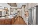 Open-concept kitchen with Viking stainless steel appliances, white cabinets and wood flooring at 5676 Case Ln, Lakeland, FL 33813