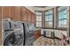 Well-equipped laundry room with abundant cabinetry, modern appliances, and natural light from the windows at 5676 Case Ln, Lakeland, FL 33813