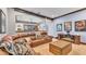 Spacious living room with a comfortable leather couch, a wooden chest, and arched doorway at 5676 Case Ln, Lakeland, FL 33813