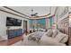 Sun-filled main bedroom features outdoor views, a beamed ceiling, and access to a private outdoor space at 5676 Case Ln, Lakeland, FL 33813