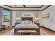 A stone accent wall highlights the bed in this primary bedroom, with stylish lighting and decor at 5676 Case Ln, Lakeland, FL 33813