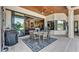 Covered patio with dining table, outdoor kitchen and a view of the backyard at 5676 Case Ln, Lakeland, FL 33813