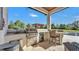 Outdoor kitchen area featuring grill, sink, mini-fridge, and bar seating at 5676 Case Ln, Lakeland, FL 33813