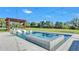 Stunning pool with sun loungers, integrated spa, decorative fire bowls, and a pergola-covered entertaining area at 5676 Case Ln, Lakeland, FL 33813