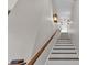 Bright staircase with white risers, wooden treads, and decorative wall sconces at 5676 Case Ln, Lakeland, FL 33813