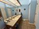 Bathroom features a double sink, updated fixtures, and soothing blue walls at 6059 Swallow Dr, Lakeland, FL 33809