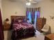 Cozy bedroom featuring wood furniture, plush carpets, and decoratively draped windows at 6059 Swallow Dr, Lakeland, FL 33809