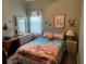 Charming bedroom with beach themed bedding, a dresser, and a decorative mirror at 6059 Swallow Dr, Lakeland, FL 33809