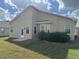 Exterior view of the backyard featuring a well-maintained lawn, patio, and side of the home at 6059 Swallow Dr, Lakeland, FL 33809