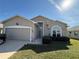 Charming single-story home with a manicured lawn, attached garage and welcoming front entrance with updated landscaping at 6059 Swallow Dr, Lakeland, FL 33809