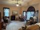 Cozy living room featuring comfortable seating, a fireplace, a ceiling fan, and large windows at 6059 Swallow Dr, Lakeland, FL 33809