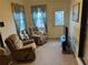 Sitting area with comfortable recliners, a TV, and a view of the outside at 6059 Swallow Dr, Lakeland, FL 33809
