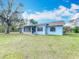 Light blue home with large backyard is fully fenced with screened porch at 6305 Tocobega Dr, Lakeland, FL 33813