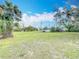 Expansive green backyard with mature trees and full fence is ready for games, pets and relaxation at 6305 Tocobega Dr, Lakeland, FL 33813