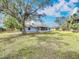 Fully fenced backyard features mature trees providing shade at 6305 Tocobega Dr, Lakeland, FL 33813