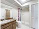 Bathroom with wood vanity, sink, toilet, shower and floral shower curtain at 6305 Tocobega Dr, Lakeland, FL 33813