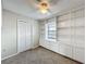 Neutral bedroom featuring a ceiling fan, built-in shelving, and natural light at 6305 Tocobega Dr, Lakeland, FL 33813