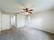 Spacious carpeted bedroom featuring a ceiling fan and closet access at 6305 Tocobega Dr, Lakeland, FL 33813