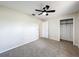 Spacious bedroom features carpet flooring, neutral walls, and open closet for storage at 6305 Tocobega Dr, Lakeland, FL 33813
