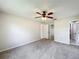 Neutral bedroom featuring a ceiling fan and en-suite bathroom access at 6305 Tocobega Dr, Lakeland, FL 33813