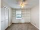 Carpeted bedroom featuring a ceiling fan, built-in shelving, and natural light at 6305 Tocobega Dr, Lakeland, FL 33813