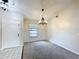 Bright entryway featuring tiled floors and a modern chandelier above the carpeted room at 6305 Tocobega Dr, Lakeland, FL 33813
