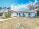 Inviting single-story home featuring blue accents and a well-kept front yard at 6305 Tocobega Dr, Lakeland, FL 33813