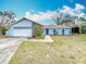 Front exterior view of the light blue home with a two-car garage at 6305 Tocobega Dr, Lakeland, FL 33813