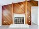 Close up on the living room fireplace with wood paneling at 6305 Tocobega Dr, Lakeland, FL 33813