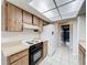 Bright kitchen with tile floors, white appliances and wood cabinets at 6305 Tocobega Dr, Lakeland, FL 33813