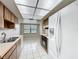 Bright kitchen with wood cabinets, white appliances, tile floors and view to backyard at 6305 Tocobega Dr, Lakeland, FL 33813