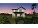 Back exterior view of a modern two-story home with a covered patio and ample yard space at 6421 Highlands Oak Trl, Lakeland, FL 33813