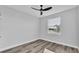 Well-lit bedroom featuring modern ceiling fan, recessed lights, gray paint, and wood-look floors at 6421 Highlands Oak Trl, Lakeland, FL 33813