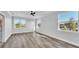 Spacious bedroom with ample natural light, featuring wood-look floors and multiple windows at 6421 Highlands Oak Trl, Lakeland, FL 33813