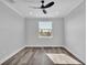 Well-lit bedroom featuring modern ceiling fan, recessed lights, gray paint, and wood-look floors at 6421 Highlands Oak Trl, Lakeland, FL 33813