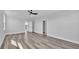 Bright bedroom boasts a modern ceiling fan and stylish gray-toned wood flooring at 6421 Highlands Oak Trl, Lakeland, FL 33813