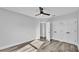 Spacious bedroom with ceiling fan, ample storage, and neutral paint scheme, enhanced by vinyl plank flooring at 6421 Highlands Oak Trl, Lakeland, FL 33813